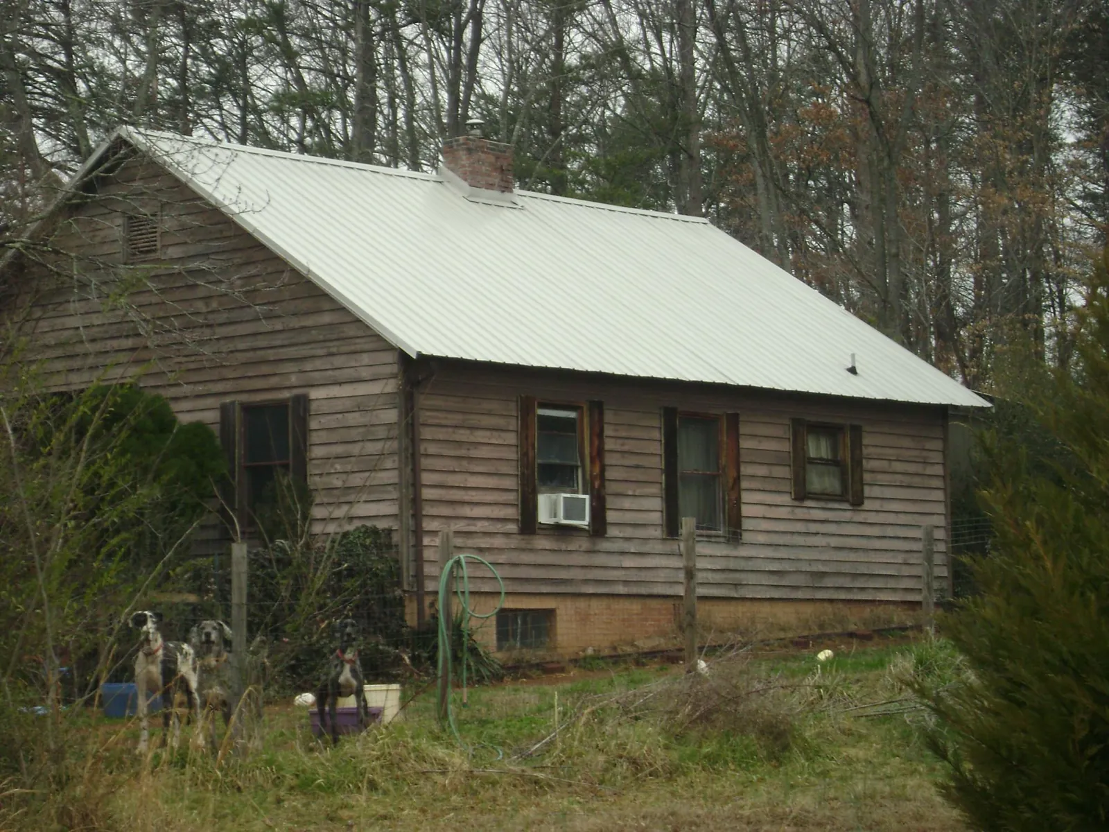White metal roof on an old wood sided farmhouse, from a Metal Roof Installation job in Vidalia